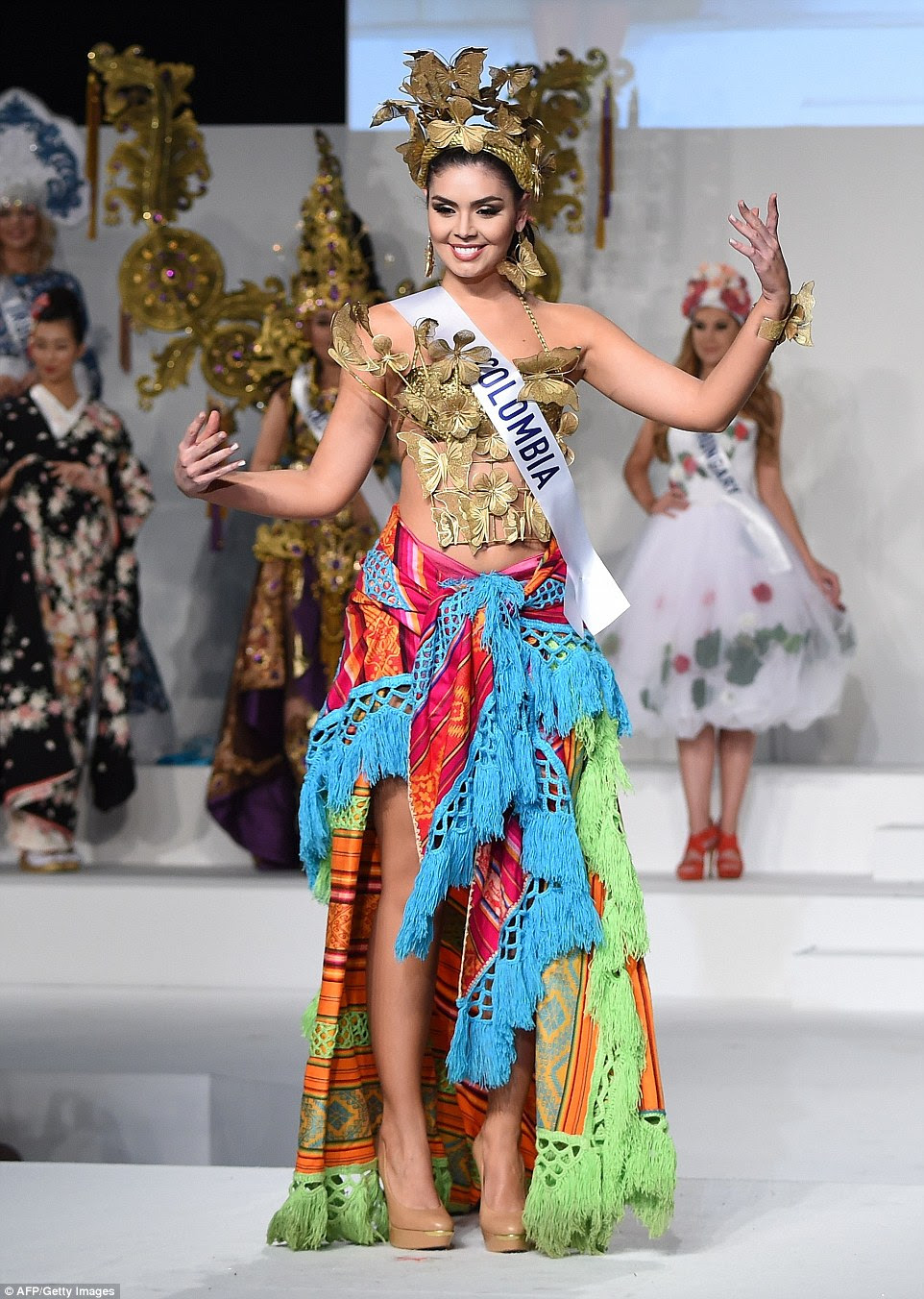 Miss Colombia appeared to take a classically colourful patterned blanket and tie it around her waist to wear as a skirt. We'll wait for that one to catch on - or perhaps she had a wardrobe malfunction with her original skirt? Either way Natalia Ochoa Calle's top and crown had a bit more effort put into them, adorned with sparkly gold butterflies and flowers