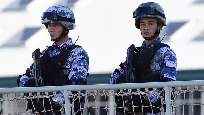 Chinese navy personnel stand guard aboard one of the warships docked at Garden Island in Sydney yesterday. Picture: AAP