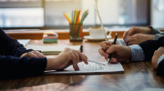 Three people review a legal document. 