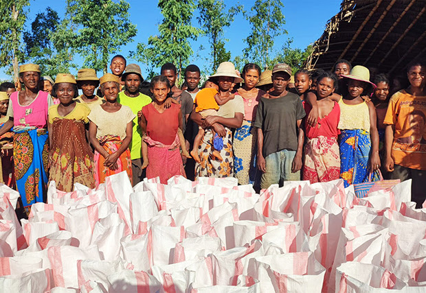 Survivors of Cyclone Freddy in Andranomavo, Madagascar, pose for a photo before receiving food aid from The United Methodist Church in Madagascar. The United Methodist Committee on Relief provided a grant to purchase rice, sugar, flour and other goods for 150 families affected by the tropical storm. Photo by Justin Rakotoarimanana.