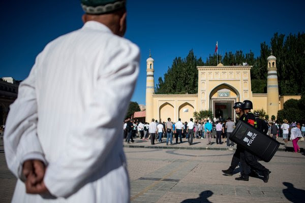 Police patrolling near the Id Kah Mosque in the old town of Kashgar in Chinaâ€™s Xinjiang region.