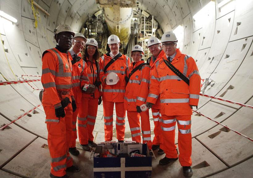 TBM Phyllis (background) receives visitors (left to right) Sam Agyeman (SCL Apprentice, Farringdon Station), Lord Deighton, Crossrail Farringdon Project Manager Nisrine Chartouny, Danny Alexander MP, Isabel Dedring, Crossrail’s Terry Morgan and Andrew Wolstenholme