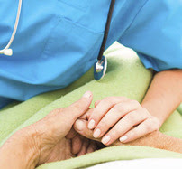 Nurse holding patient's hand