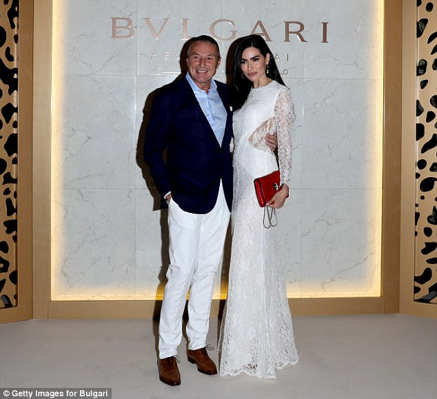 Looking good: Bulgari CEO Jean-Christophe Babin wore a pair of winter white trousers with a navy blue blazer alongside Diala Makki in a gorgeous white dress
