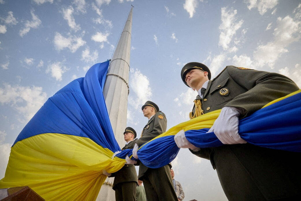 Members of the honor guard attend a rising ceremony of Ukraine's flag to mark national flag day in Kyiv on Aug. 23. (Ukrainian Presidential Press Service/Reuters)