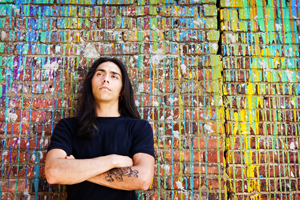 Young man leaning against a wall