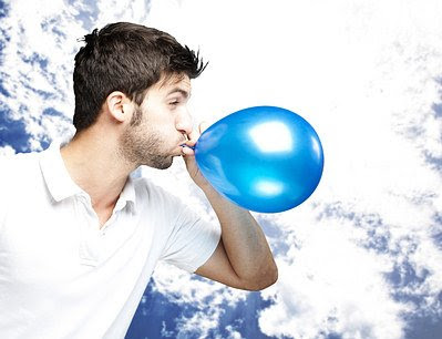 blowing a balloon