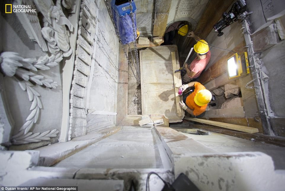 The burial slab (pictured being revealed from its marble case) many Christians believe once held the body of Jesus Christ has been uncovered by scientists for the first time in centuries. The original surface, partially shown in this picture, was exposed during restoration work at the Church of the Holy Sepulchre in the Old City of Jerusalem