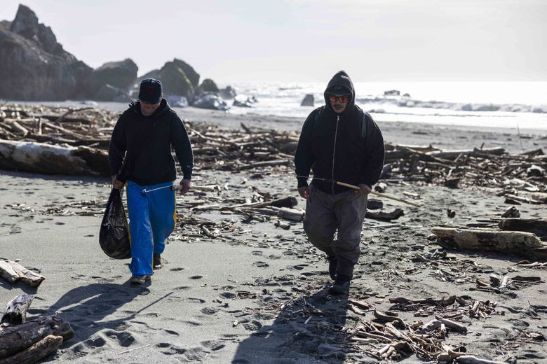 River Richards, left, and Sheldon SmilingCoyote call it a day after catching slimy lamprey using the traditional fishing technique of lassoing the prehistoric fish over their heads with a hook. The men caught two dozen lampreys in one day. (Daniel Kim / The Seattle Times)
