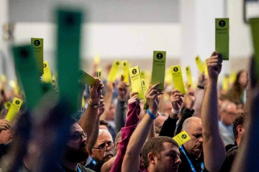 People attending the Southern Baptist Convention annual meeting in Anaheim California raise yellow ballots overhead.