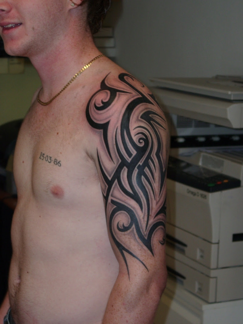 Chest And Half Sleeve Tribal Tattoos