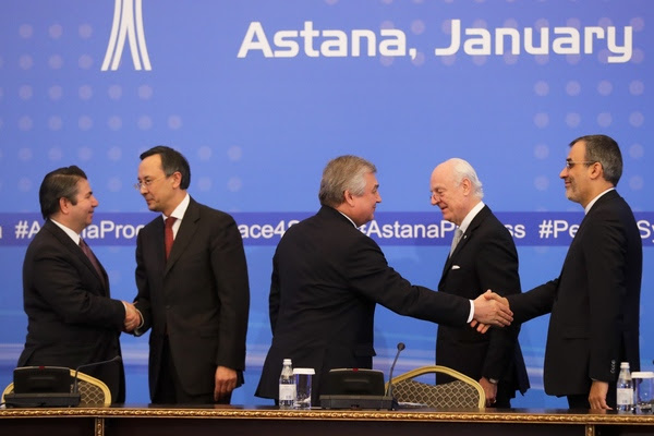Officials from Turkey,&nbsp;Kazakhstan,&nbsp;Russia, Iran, and the UN shake hands following Syria peace talks in&nbsp;Astana, Kazakhstan, on&nbsp;Jan. 24. (Sergei Grits/AP)</p>
