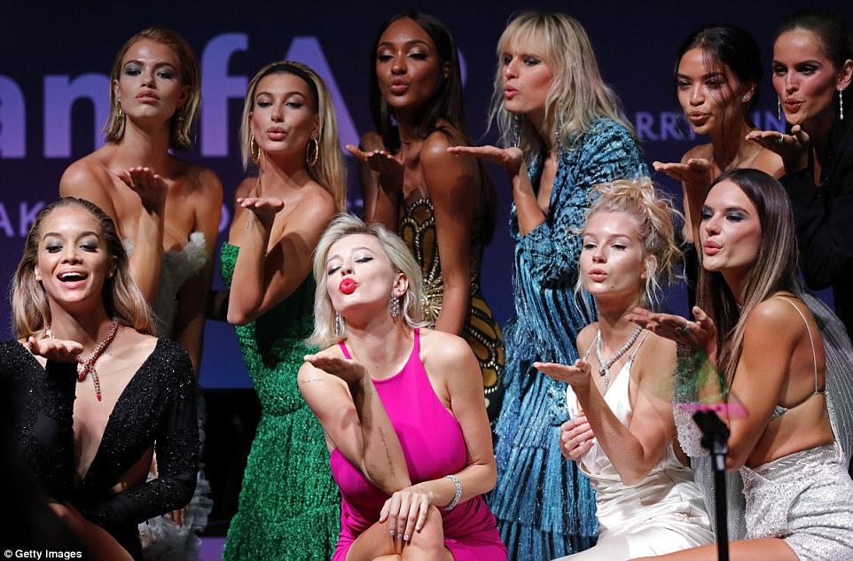 Playful: The gorgeous women blew kisses as they shared the stage during Milan Fashion Week