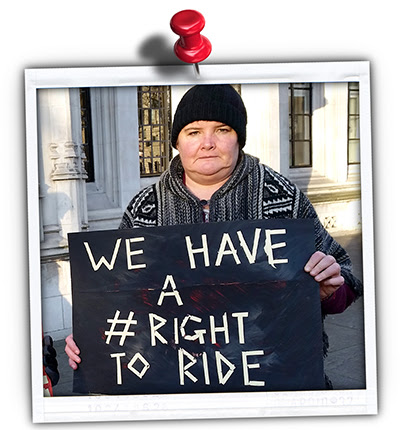 Picture of a TfA member holding a sign saying "We have a right to ride"