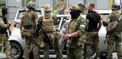 Members of Wagner group inspect a car in a street of Rostov-on-Don, on June 24, 2023. President Vladimir Putin on June 24, 2023 said an armed mutiny by Wagner mercenaries was a "stab in the back" and that the group's chief Yevgeny Prigozhin had betrayed Russia, as he vowed to punish the dissidents. Prigozhin said his fighters control key military sites in the southern city of Rostov-on-Don. (Photo by STRINGER / AFP)