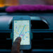 A Lyft driver, with a pink furry mustache on the dashboard, makes his way through Midtown Manhattan.