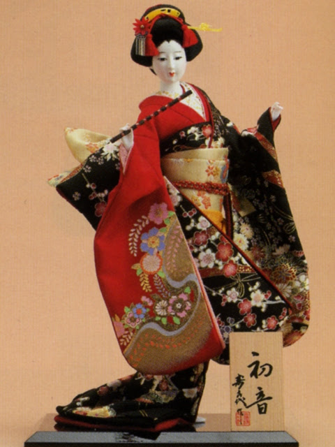 Dolls are in unique posts holding fan, umbrella, flute, drum, etc. Geisha Doll