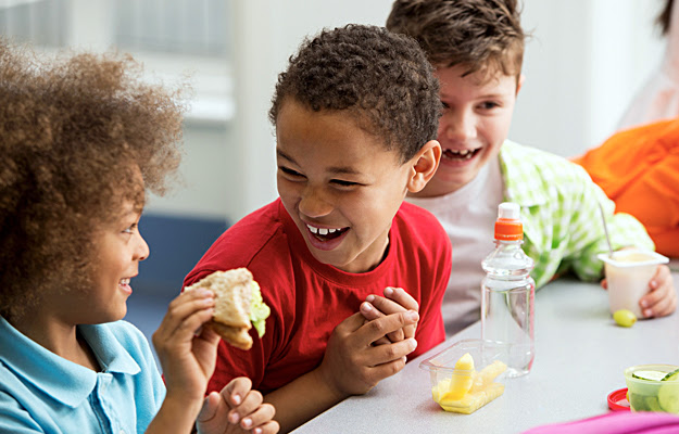 Students eating healthy packed lunches.