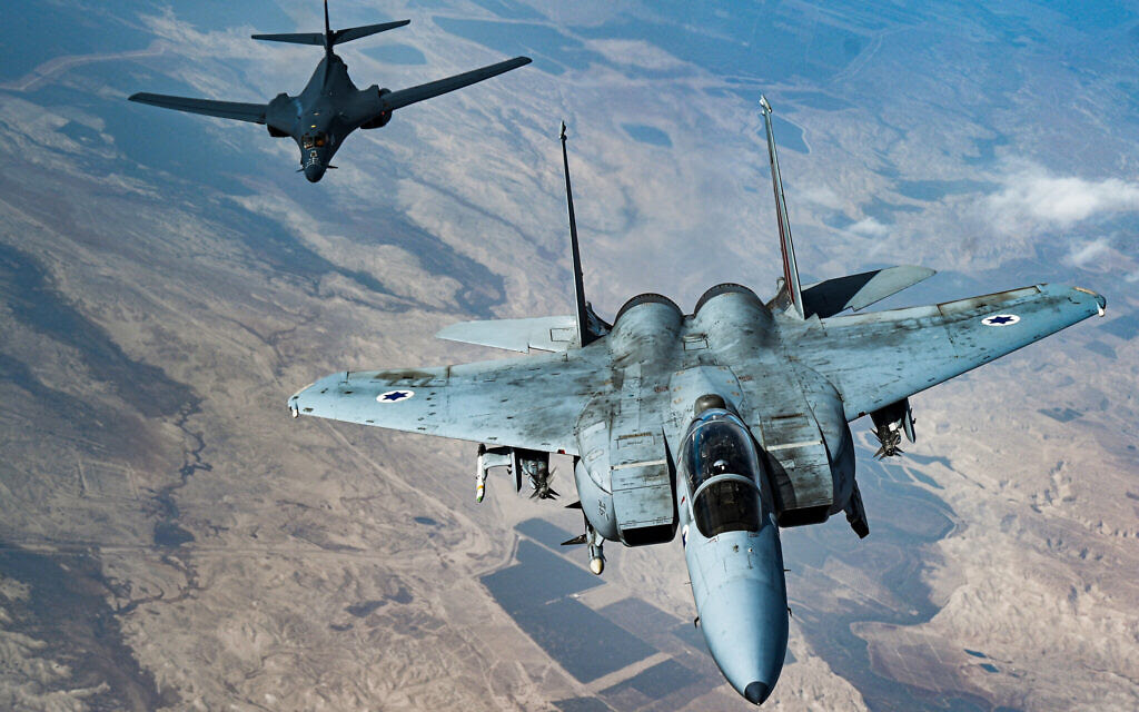 In this photo released by the US Air Force, an Israeli Air Force F-15 Strike Eagle flies in formation with a US Air Force B-1B Lancer over Israel as part of a deterrence flight Saturday, Oct. 30, 2021. (US Air Force/Senior Airman Jerreht Harris via AP)