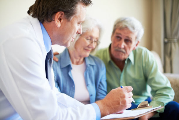 older white couple speaks with doctor