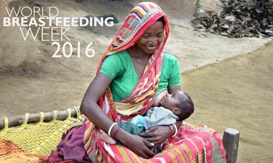 A woman breastfeeds her child in India.