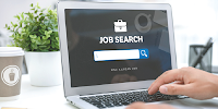 A laptop open to a screen that reads ‘job search.’