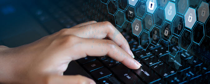 hands typing on a computer