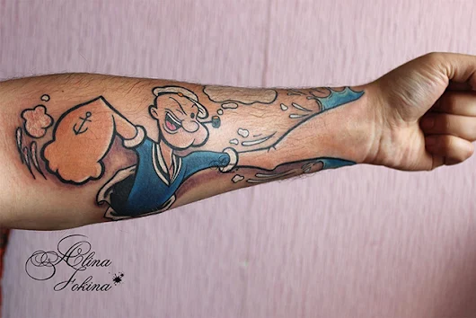 Forearm Tattoo of Popeye the Sailor Man’s Fist Blending Into the Tattooed Person’s Hand
