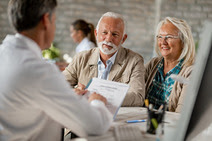 man and woman couple speaking to doctor