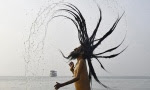 A Sadhu, or a Hindu holy man, takes a dip at the confluence of the river Ganges and the Bay of Bengal, ahead of the "Makar Sankranti" festival at Sagar Island, south of Kolkata January 13, 2015. REUTERS/Rupak De Chowdhuri