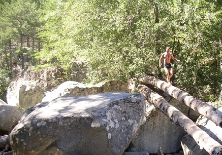 erwan walking across log