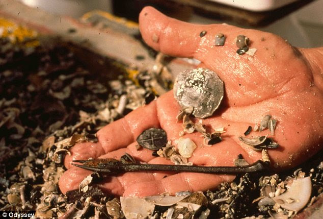 Examination: An archaeologist holding silver retrieved from the wreck 400m deep in the Gulf of Mexico