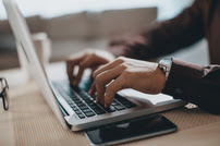 Man Typing on Laptop; Only Hands Shown