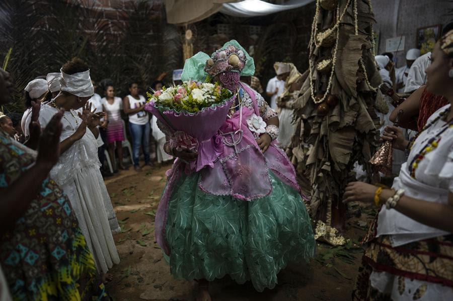 Members of the Afro Brazilian faith, Candomble, dance during a ritual honoring Obaluae, the deity of earth and health.
