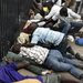 Students scooting under the gates of the United States Embassy in Bujumbura, Burundi, on Thursday as the police sought to break up their encampment.