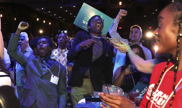 Supporters cheer as Michigan Democratic gubernatorial candidate Gretchen Whitmer is declared the winner in the primary, Tuesday, Aug. 7, 2018, in Detroit. Whitmer will face Republican Bill Schuette in November. (AP Photo/Carlos Osorio)