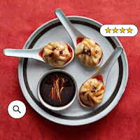 Soup dumplings on a red plate with search and rating icons
