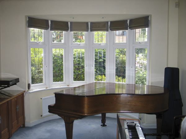 Five panel round bay window styled with shutters in full height from our california range in 87mm louvers • #baywindow #homestyling #window #decorating #windows #design #interiordesign. Roman Blinds All Round Bay Window In Andrew Martin Silk Hampstead North London