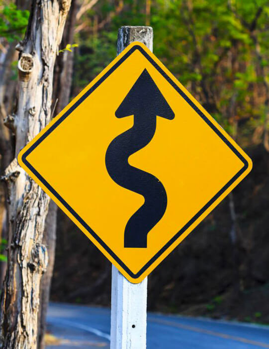 A driver preparing to enter the main road may not be able to see you. Winding Road Sign What Does It Mean