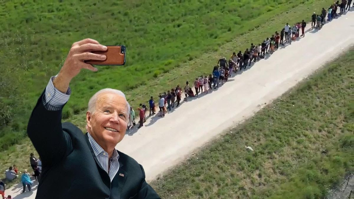 Fake picture of Biden taking selfie with immigrants.