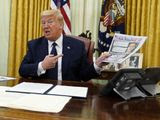 President Donald Trump holds up a copy of the New York Post as speaks before signing an executive order aimed at curbing protections for social media giants, in the Oval Office of the White House, Thursday, May 28, 2020, in Washington. (AP Photo/Evan Vucci)