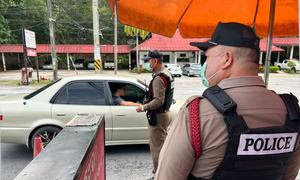 Policías revisando vehículo en una carretera del norte de Tailandia.