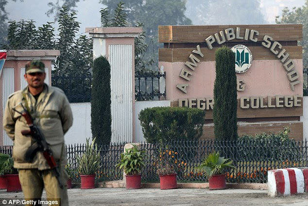 A Pakistani frontier corp guard  stands outside the main entrance of the army-run school