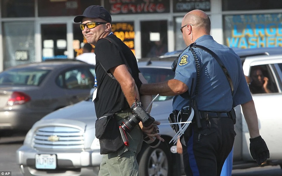 Getty Images photographer Scott Olson was arrested while covering demonstrators on Monday for apparently not being in the required media area