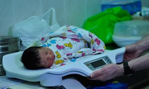 Un bebé recién nacido es pesado en una báscula en un hospital de Ucrania (archivo).