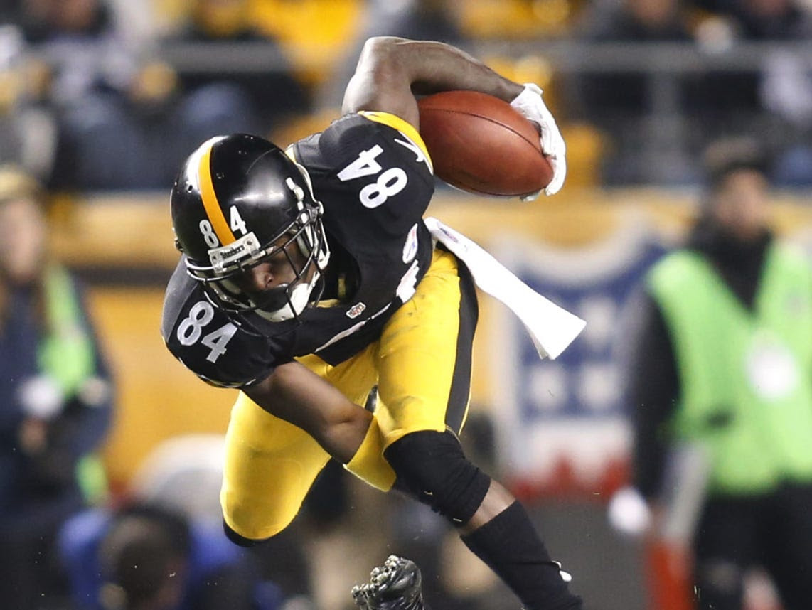 Nov 2, 2014; Pittsburgh, PA, USA; Pittsburgh Steelers wide receiver Antonio Brown (84) leaps over Baltimore Ravens defensive back Will Hill (bottom) after pass reception during the third quarter at Heinz Field. The Steelers won 43-23. Mandatory Credi