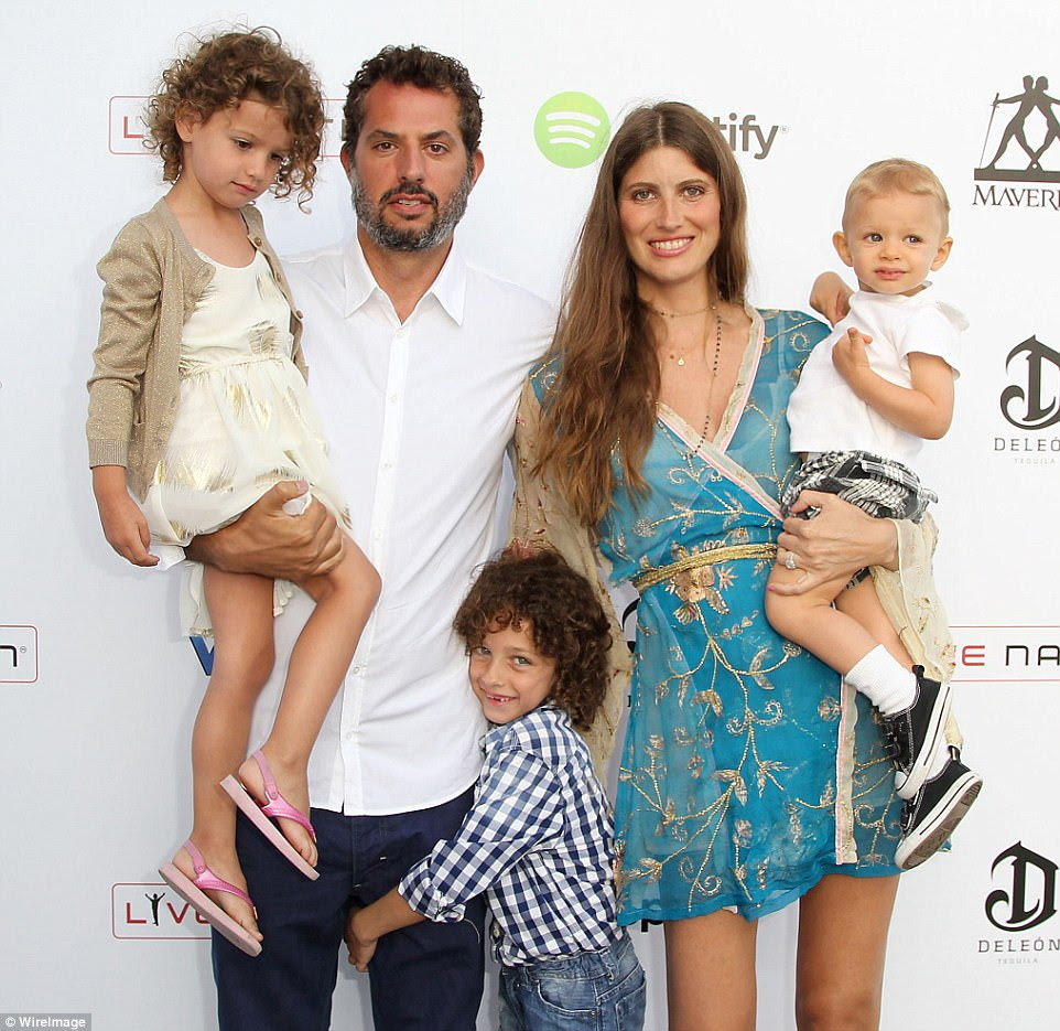 Family guy: Guy and Brazilian model Michelle, 39, at an event with their children, Oliver, 11, Mia, eight, and Levi, five, back in 2013