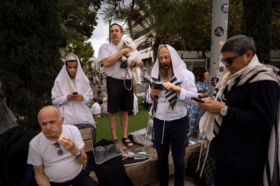 Jewish men attend an outdoor prayer and celebration of the Jewish holiday of Passover.