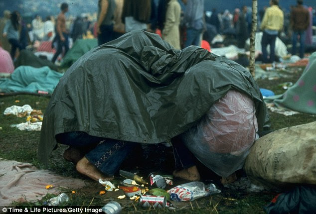 Wet and wild: The rain did little to deter hundreds of thousands of young people from sticking around at the festival