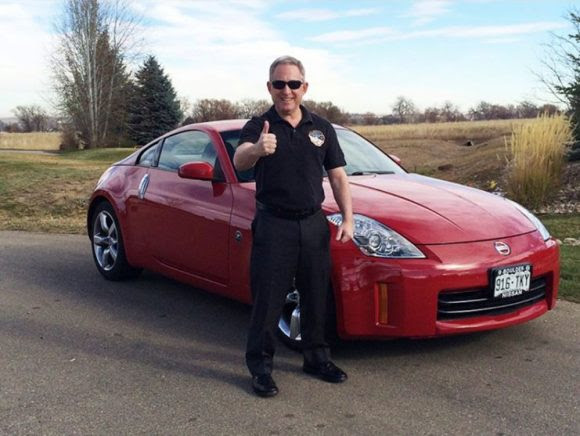 New Horizons Principal Investigator Alan Stern and the Nissan sports car he has donated to the Lowell Observatory for a fundraiser. Credit: Lowell Observatory. 